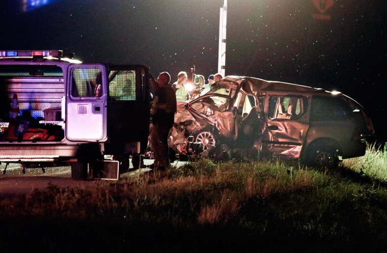 Image:  Rescue personnel and police investigate a deadly two-vehicle crash on U.S. 27 in Nicholasville, Ky.
