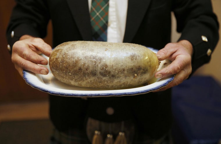 Image: A Haggis is carried at a Burns supper in Killiecrankie