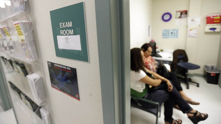 Image: Two women wait in an exam room at Nuestra Clinica Del Valle, in San Juan, Texas on July 12, 2012.