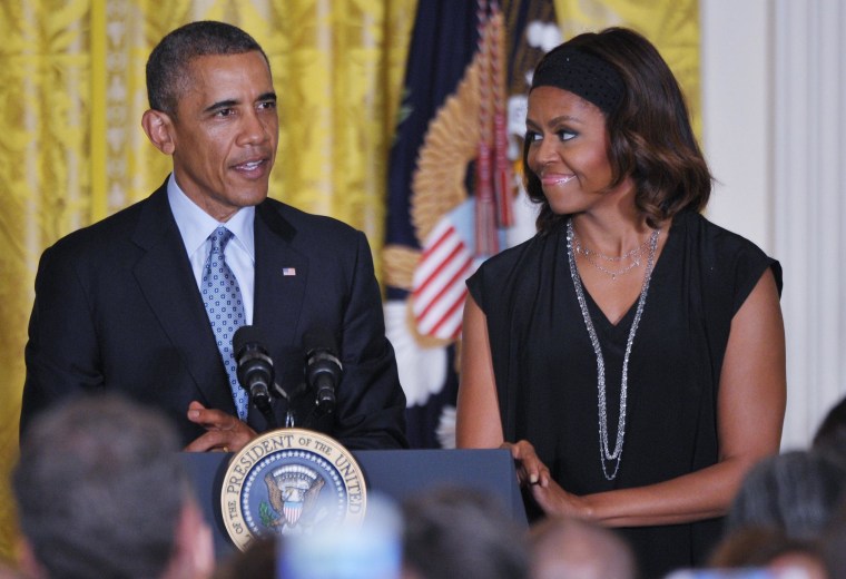 Image: U.S. President Barack Obama speaks during a reception celebrating LGBT Pride Month as First Lady Michelle Obama watches on June 30 in the East Room of the White House in Washington.