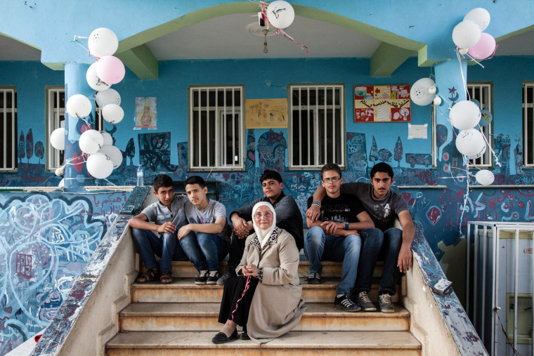 Image: Headmistress Hazar Mahayni sits on the steps of the Al Salam school in Reyhanli, Turkey.