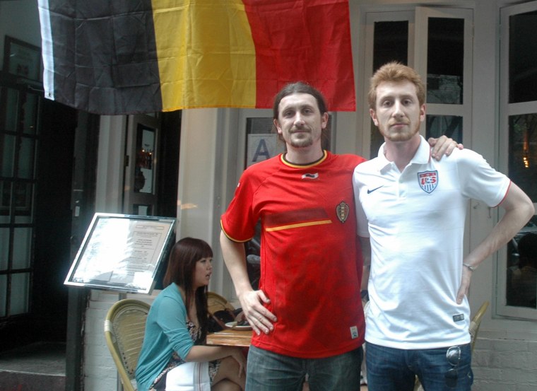Image: Amael Feuillard and his brother, Uriell, pose outside the Belgian bar that Amael manages