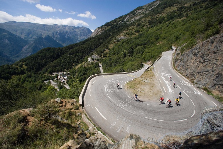 Image: Trek Travel riders navigate a switchback turn in the Alps.