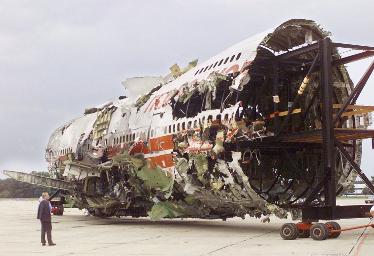 Image: Jim Hall, chairman of the National Transportation Safety Board, looks on as the reconstruction  of TWA Flight 800