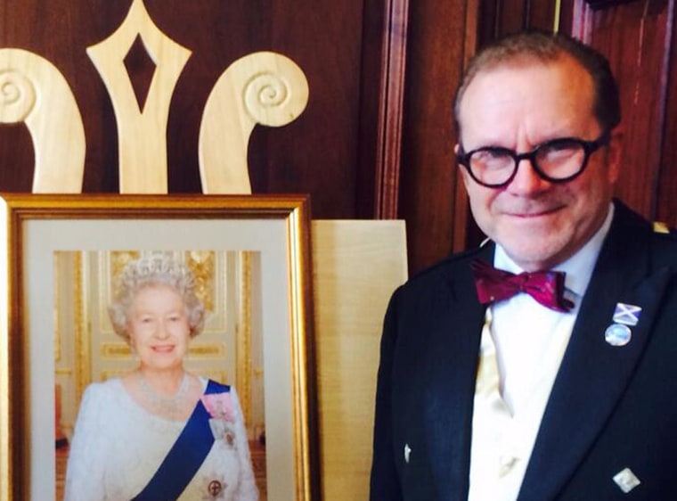 Joe Goldblatt, a Texan who has lived in Scotland for more than a decade, poses next to a portrait of Queen Elizabeth after he gained dual U.S.-British citizenship last month.