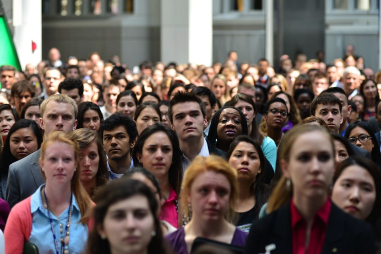 Image: Millenials watch a video calling on the millennial generation to help end the problem of extreme poverty around the globe during the IMF/World Bank Group's Spring summit on April 10, 2014.