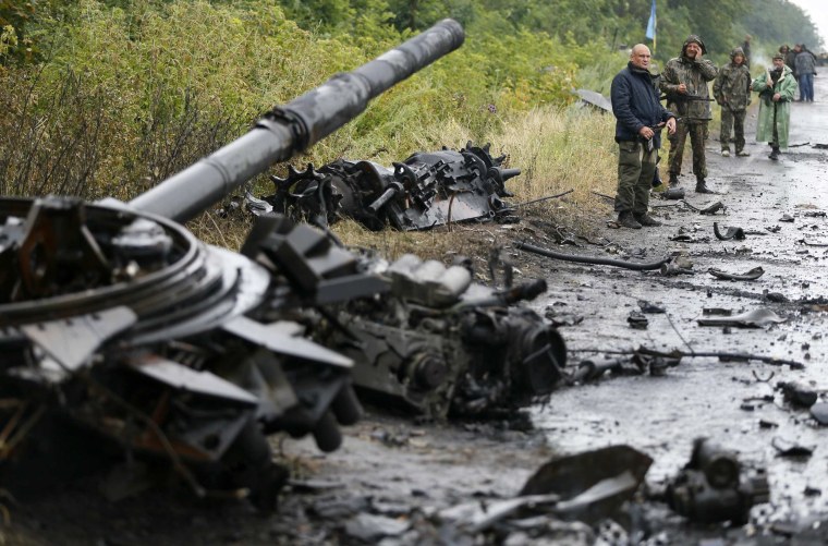 Image: Ukrainian troops stand near destroyed military vehicles just outside Slaviansk