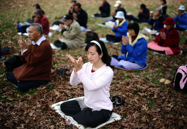 Image: Members of Falun Gong spiritual movement meditate at the Lafayette Park in front of the White House in Washington, DC, on Nov. 20, 2011.