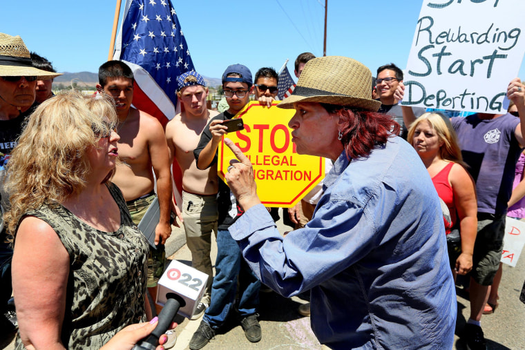 Anti-undocumented immigration activist Sabina Durden, right and immigration sympathizer Mary Estrada, left, debate during a protest outside of the U.S. Border Patrol Murrieta Station on July 7, 2014 in Murrieta, Calif.  Immigration protesters have staged rallies in front of the station for about a week in response to a wave of undocumented immigrant children caught along the U.S.-Mexico border in Texas and transported to the Murrieta facility while awaiting deportation proceedings.