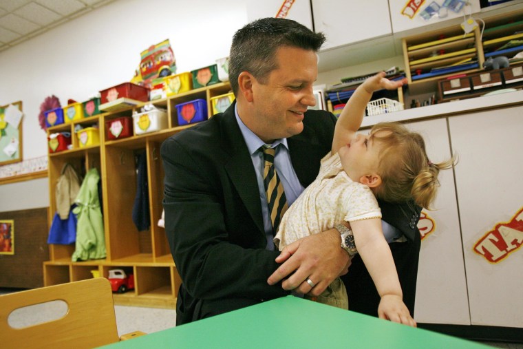 Image: James Cowen says goodbye to his daughter Samantha Cowen, 2, after dropping her off at daycare in Washington, on May 16, 2008.