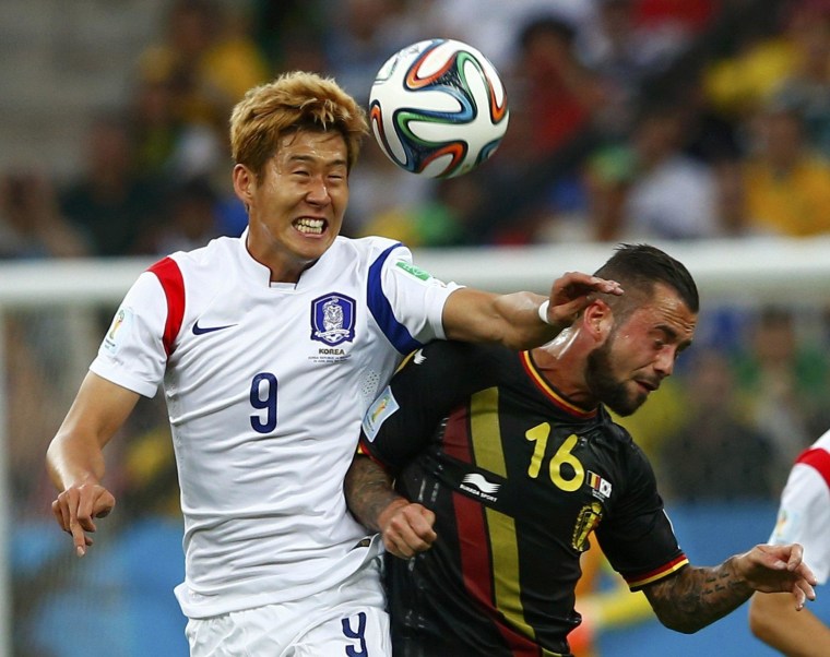 Image: South Korea's Heung-min and Belgium's Defour fight for the ball during their 2014 World Cup Group H soccer match at the Corinthians arena in Sao Paulo