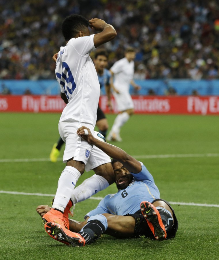 England's Raheem Sterling runs into Uruguay's Alvaro Pereira with his knee during the group D World Cup soccer match between Uruguay and England at the Itaquerao Stadium in Sao Paulo, Brazil, on June 19. Pereira was knocked out by the blow.  