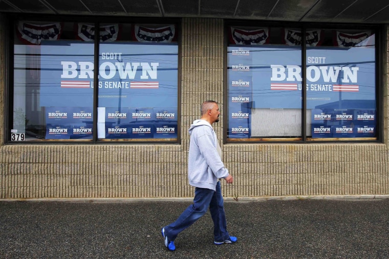 Image: A pedestrian walks past the campaign offices for Republican candidate for the U.S. Senate Scott Brown in Manchester