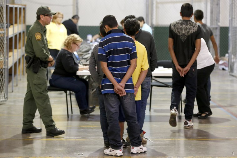 Boys wait in line to make a phone call as they are joined by hundreds of mostly Central American immigrant children that are being processed and held at the U.S. Customs and Border Protection Nogales Placement Center in Nogales