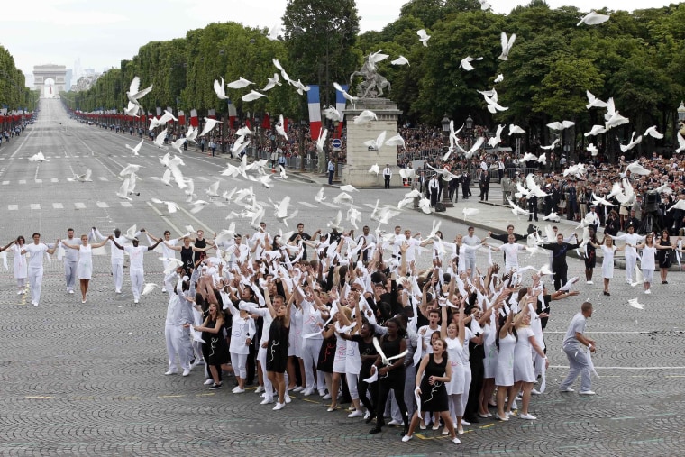 Youths release doves at the end of the traditional Bastille Day parade on the Place de la Concorde in Paris, on July 14. The year 2014 marks the 100th anniversary of the start of the First World War.