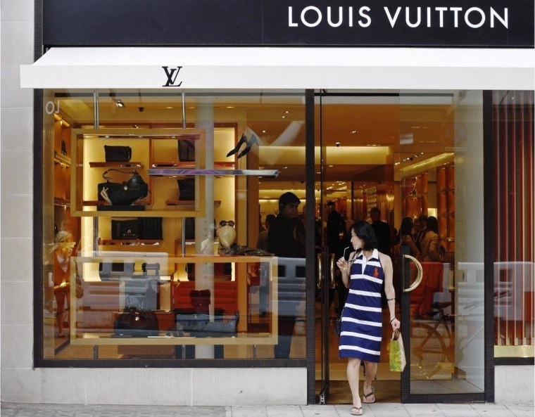 Woman exits Louis Vuitton shop