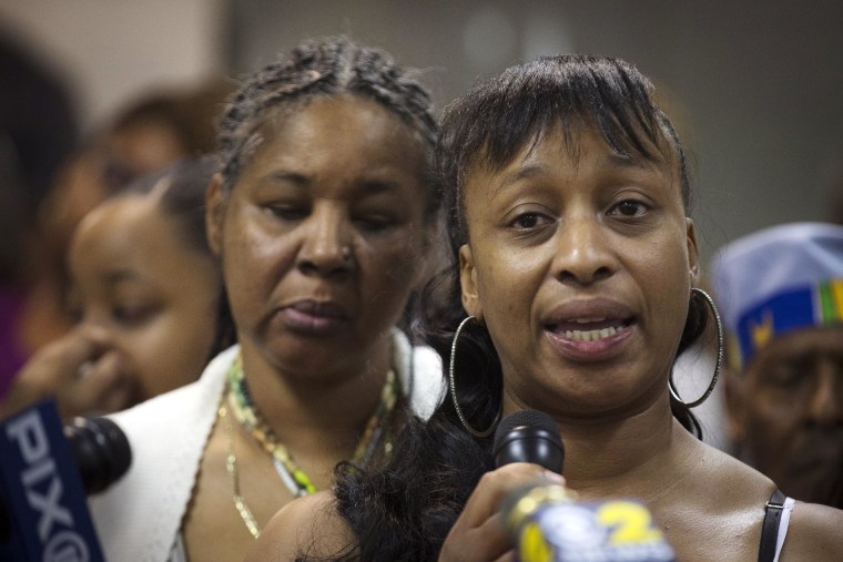 Image: Ellisha Flagg, sister of Eric Garner, speaks beside his wife Esaw Garner, left, during a service at the Mount Sinai Center for Community Enrichment for Eric Garner