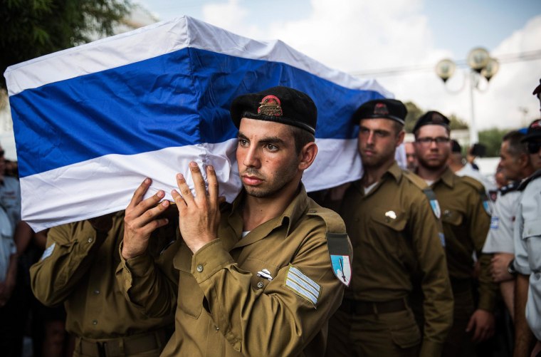 Image: The casket carrying Israeli Sergeant Adar Barsano is carried to a burial plot in a cemetary during his funeral on July 20 in Nahariya, Israel.