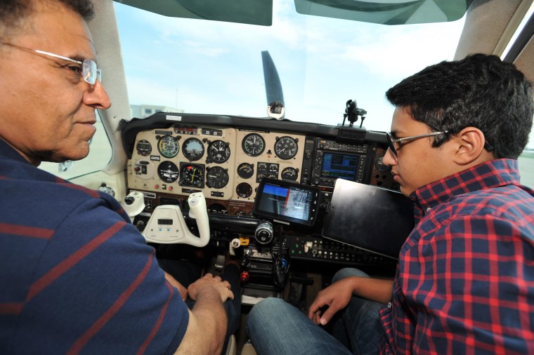 Image: Babar Suleman, left, and son, Haris Suleman, right, sit inside their Beechcraft Bonanza plane