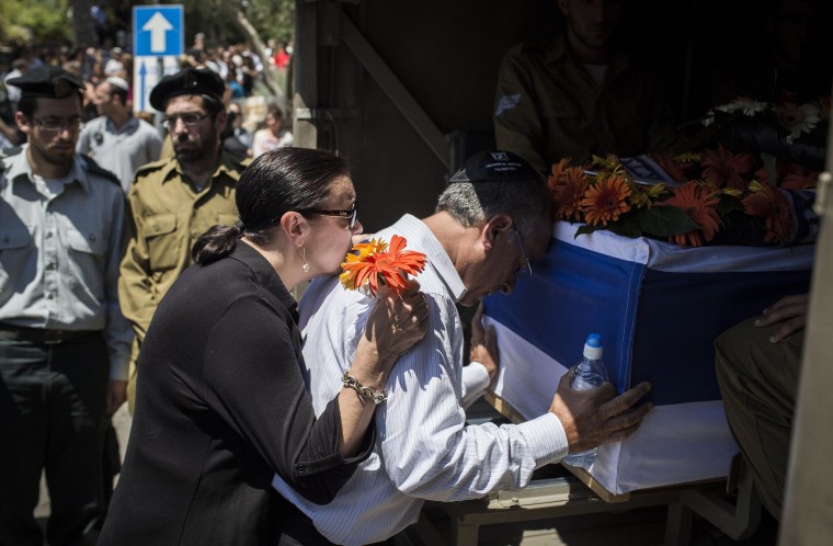 Image: The parents of Sergeant Max Steinberg grieve at his coffin