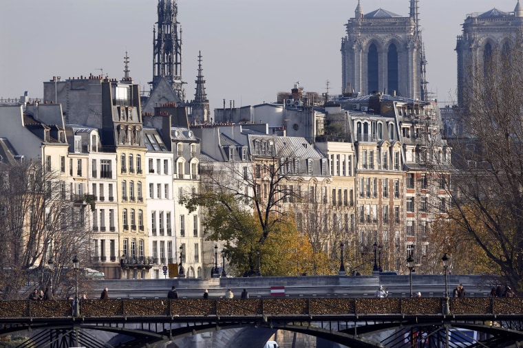 View of the Pont des Arts with its fence covered with love padlocks and the Pont Neuf over the River Seine in Paris