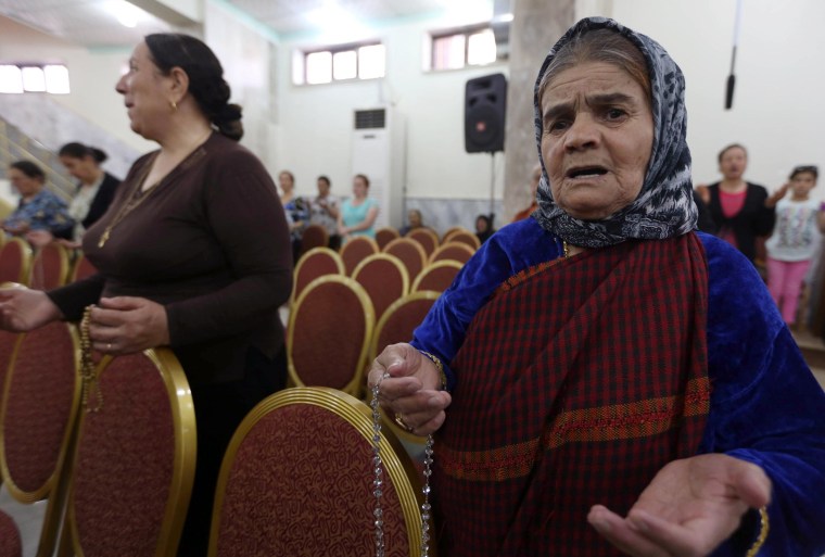 Image: Iraqi Christians who fled the violence in the northern city of Mosul