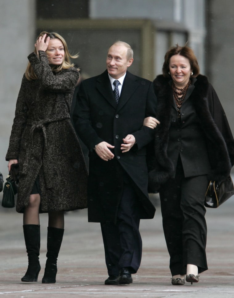 Image: Russian President Vladimir Putin, daughter Maria, left, and his wife Lyudmila, right, walk to a polling station in Moscow, on Dec. 2, 2007.
