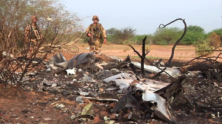 French soldiers stand by the wreckage of the Air Algerie Flight 5017 which crashed in Mali's Gossi region, west of Gao, on July 24.