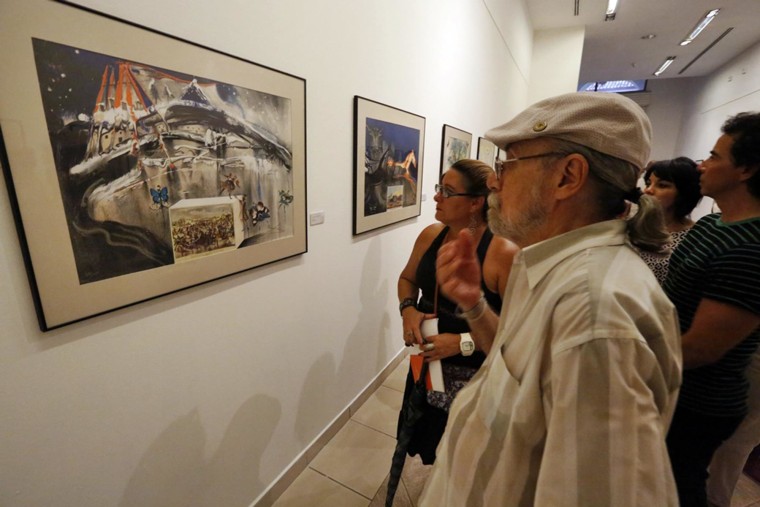 Viewers enjoying the "Memories of Surrealism" at the Museum of Fine Arts in Havana.  The exhibit comprises major works by the late surrealist painter Salvador Dalí.