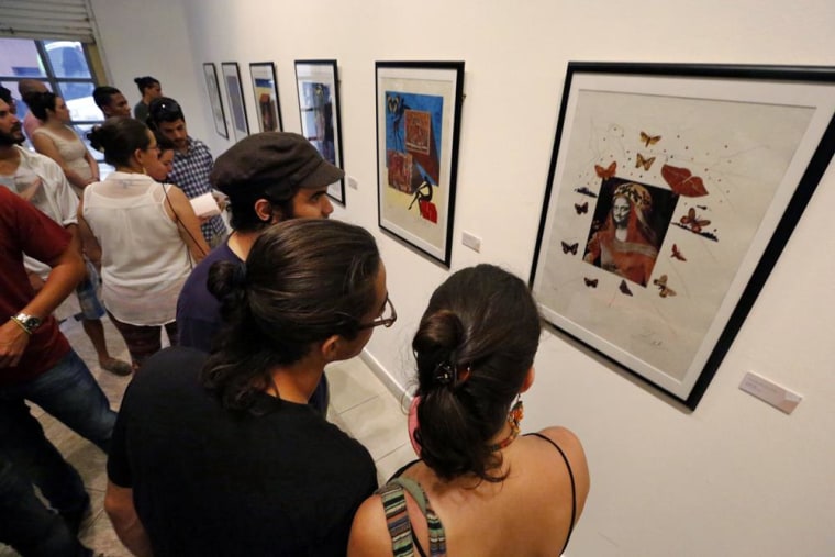 Viewers enjoying the exhibit "Memories of Surrealism" in Havana, Cuba.