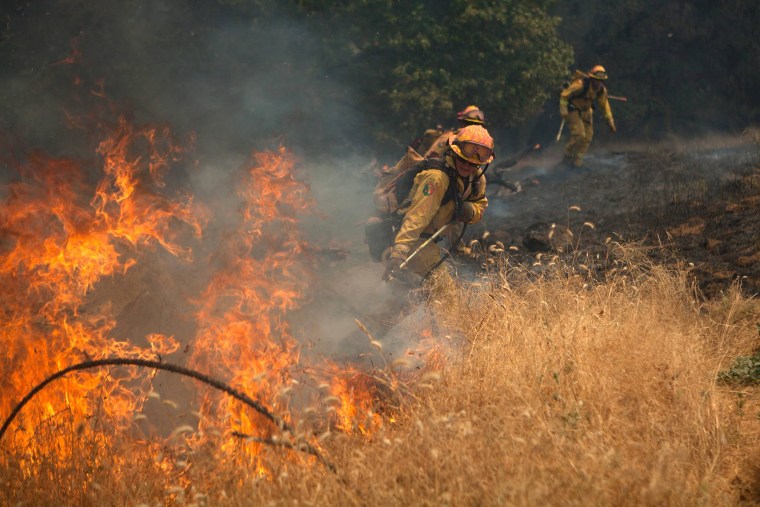 Image: Members of the CAL Fire Vina Helitack crew battle the 'Sand Fire' near Plymouth, California