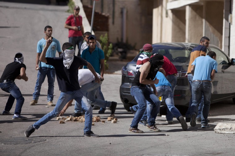 Image: Palestinian protesters hurl stones at Israeli soldiers