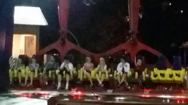 People sit on the Skyhawk ride at Cedar Point after a cable snapped on Saturday night.