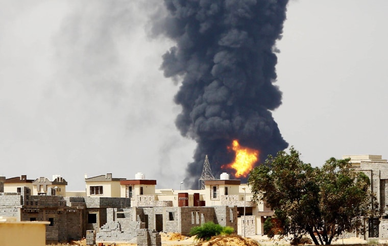 Image: Flames and smoke billow from an oil depot in Tripoli