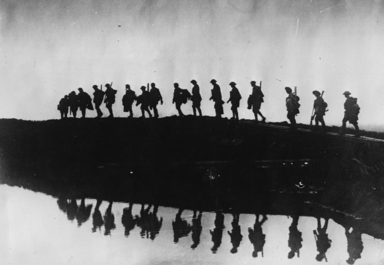 Image: Supporting troops of the 1st Australian Division form a silhouette against the sky as they move toward the front line to relieve their comrades, whose attack the day before won Broodseinde Ridge during World War I.