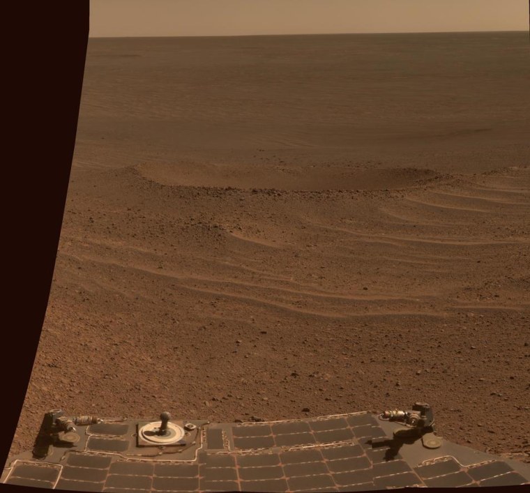 This true-color view from NASA's Opportunity rover shows Lunokhod 2 Crater, a newly named Martian feature that lies south of Solander Point on the west rim of Endeavour Crater. Lunokhod 2 Crater is approximately 20 feet (6 meters) in diameter. The view was obtained was obtained on April 24. Part of the rover is visible at bottom.