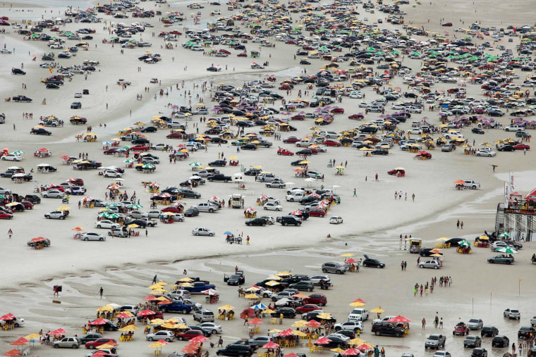 Image: A view of thousands of beachgoers during the peak of the summer vacation season on Atalaia beach in Salinopolis