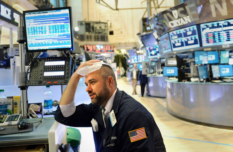 It's enough to give anyone a headache! A trader on the New York Stock Exchange reacted as stocks fell over 1 percent on Thursday.