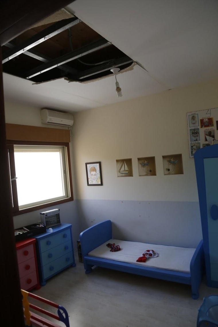 Part of the ceiling collapsed in a child's room in Iris Zilberman's home from the shock wave of a Hamas rocket that landed in the yard next door.