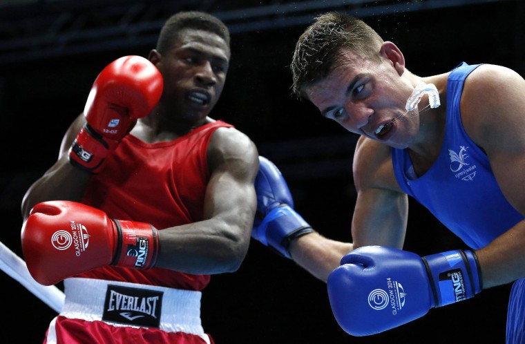 Image: Wales' Thorley loses his mouth guard from a punch from Mauritius' St. Pierre during their men's Light Heavy Weight boxing match at the 2014 Commonwealth Games in Glasgow