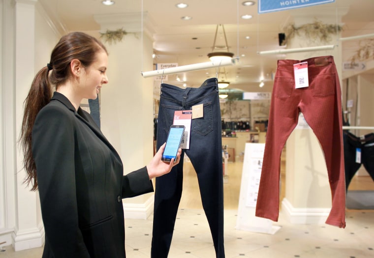 Image: A woman demonstrates Hointer's shopping technology.