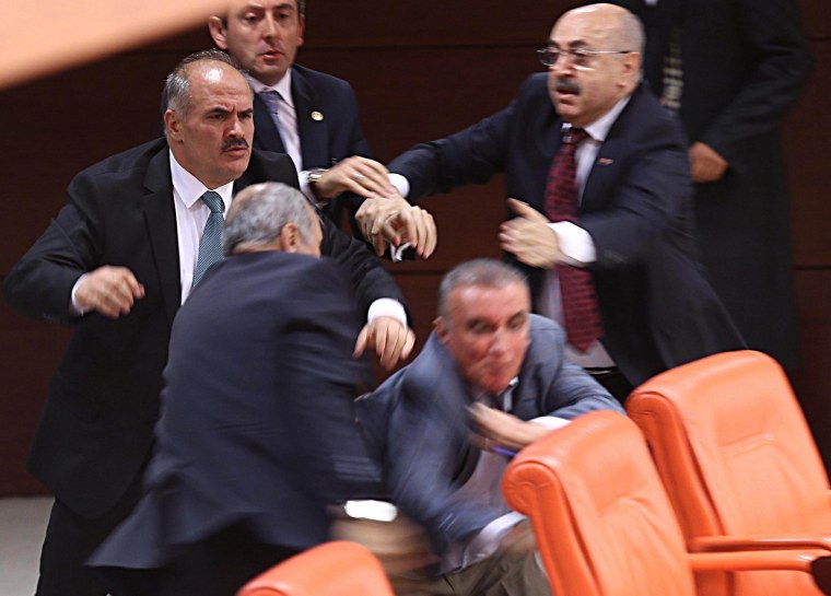 Image: Opposition MHP party deputy Ali Uzunirmak (2nd R)  fights with AKP's deputy Mustafa Sahin (2nd L)