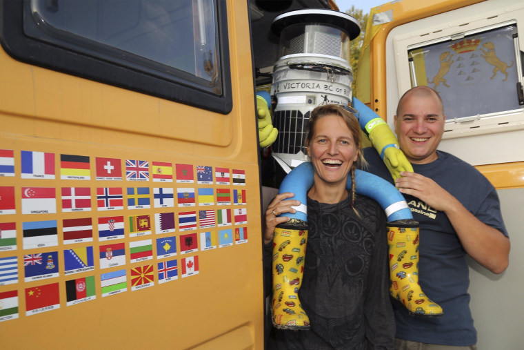 Image: HitchBOT is seen with Belgian tourists Kim Van Aerde and Seb Leeson in Sault Ste. Marie, Ontario