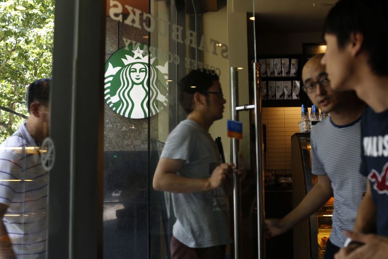 Image: Customers enter a Starbucks store in Shanghai