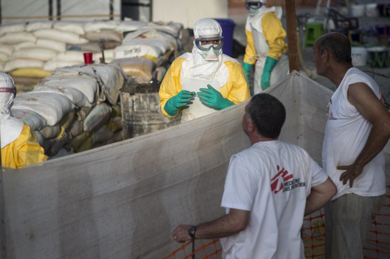 Image: The logistics team from Doctors Without Borders erects an incinerator in the Ebola isolation ward in Conakry, Guinea