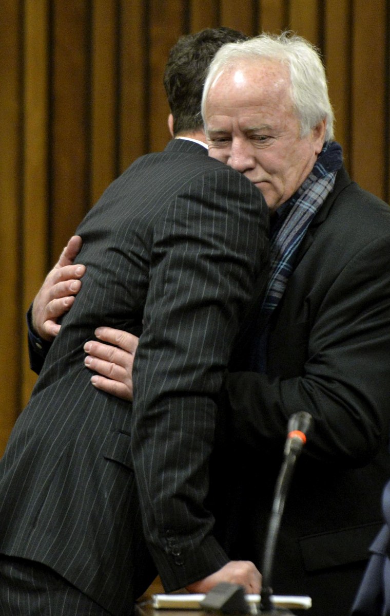 Image: Oscar Pistorius gets a hug from his father in the Pretoria High Court