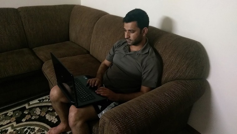 Dakhel Zanadinan, of Lincoln, Nebraska, checks for news from Iraq.