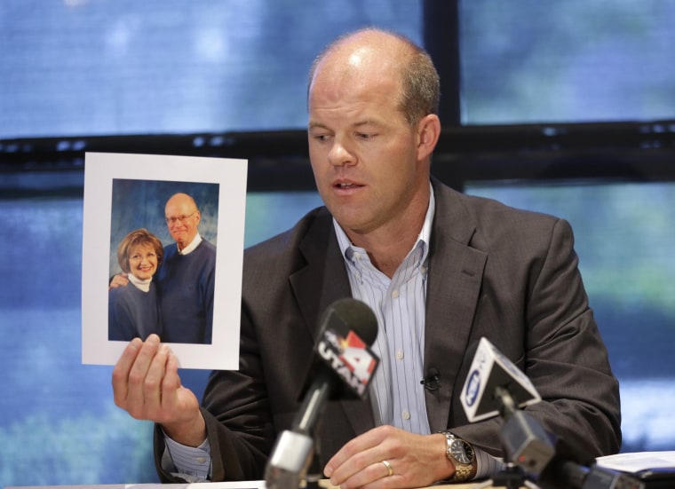 Image: Attorney Paxton Guymon holds a photograph of Jim and Jan Harding