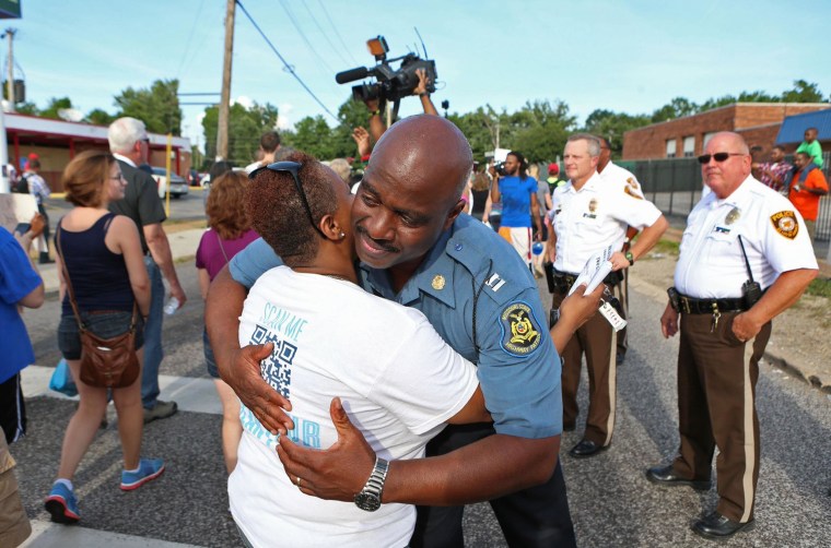 Image: Capt. Ron Johnson of the Missouri Highway Patrol hugs Angela Whitman
