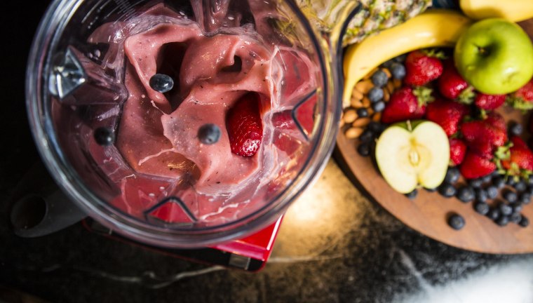 Image: Blueberries and strawberries are combined with coconut milk and bananas for a smoothie.